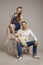 Young family sits on a ladder with Teddybear