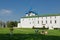 A young family with a small child sitting on the grass in Suzdal Kremlin. Suzdal, Russia