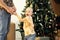 a young family with a small child unwraps gifts near the Christmas tree