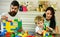 Young family spends time in playroom. Family and childhood concept