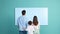 The young family stands next to a big blank screen , concept of Colorful backdrop, created with Generative AI technology