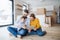 A young family with a toddler girl moving in new home, using tablet.