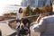 Young family with two daughters taking a photo on footbridge