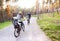 Young family in warm clothes cycling in autumn park