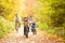 Young family in warm clothes cycling in autumn park