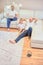 Young family watching television, two guys and a little boy sitting on the sofa and the floor in the living room at home