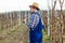 Young farmer checking blossom in orchard.