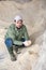 Young farmer checking quality of soy flour in livestock farm storage