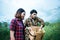 Young farmer couple harvest fresh asparagus  together put into the basket