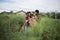 Young farmer couple harvest fresh asparagus  together put into the basket