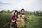 Young farmer couple harvest fresh asparagus together put into the basket