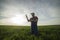 A young farmer examines planted young wheat