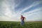 A young farmer examines planted young wheat