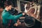 Young farmer feeding calf in the cowshed in dairy farm