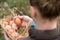 A young farmer female holding a fresh hen egg and other eggs in