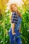 Young farmer girl on corn field.