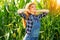 Young farmer girl on corn field.