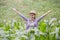 Young farmer happy and put hands up in a corn field, the concept