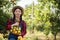 Young farmer  holding sweet orange trees in hands. Farmer gathering autumn orange harvest