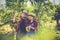 Young farmer  holding sweet orange trees in hands. Farmer gathering autumn orange harvest