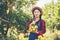 Young farmer  holding sweet orange trees in hands. Farmer gathering autumn orange harvest