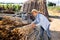 Young farmer preparing bamboo stems for making support trellises