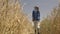 young farmer rubber boots walks through wheat field rubber boots. farming concept. organic food agriculture. business