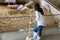 Young farmer with shovel working in in organic farm pig. Agriculture and livestock industry