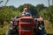 Young farmer woman driving her old tractor