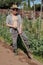 Young farmer working soil with shovel