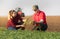 Young farmers examing planted wheat fields