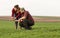 Young farmers examing planted young wheat during winter season