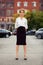 Young fashion business woman standing on car parking