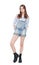 Young fashion girl in jeans overalls posing isolated