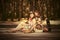 Young fashion girls with fruit baskets in summer forest