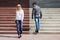 Young fashion man and woman flirting on the steps