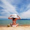 Young fashion woman relax on the beach with coconut. Happy lifestyle. White sand, blue sky and crystal sea of tropical beach.