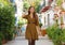 Young fashion woman walking in Alicante old city street, Spain. Beautiful elegant girl visiting southern Europe