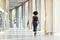 A young fashionable Afro-American woman walking away from the camera