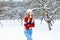 Young fashionable girl in a warm vintage winter clothes in winter snowy day.