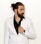 Young, fashionable male model with long hair and beard posing in studio on isolated background. Fashion, business, modeling