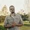 Young fashionable man with sunglasses outddoors. Analog film portrait shot on square medium format ratio