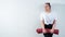 Young fat caucasian woman holding a sport mat. Charming plus size model in sportswear stands on a white background