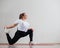 Young fat woman doing flexibility exercises on a white background