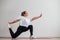 Young fat woman doing flexibility exercises on a white background