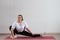 Young fat woman doing flexibility exercises on a white background