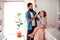 A young father brushing hair of small daughter in bathroom at home.