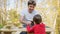 Young father building wooden playhouse with his son