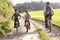 Young father with children ride bikes in park