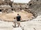 Young father dad and his school boy kid son tourists visiting ancient antique coliseum amphitheater ruins in hot summer